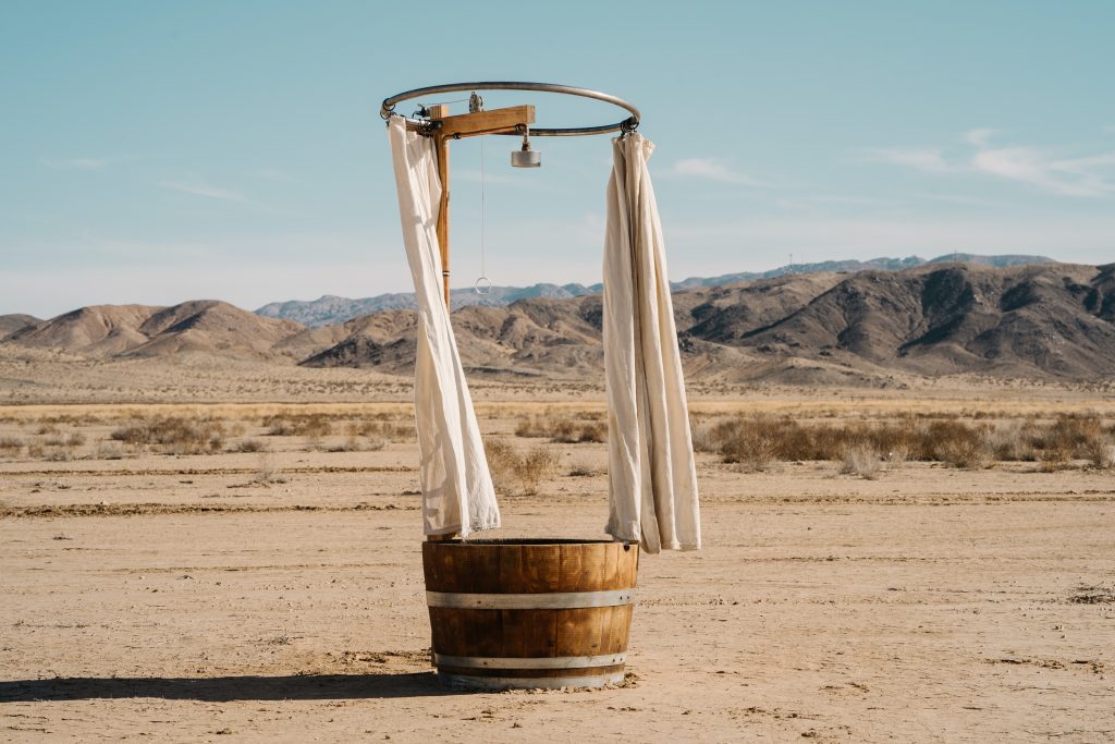 Shower in the desert on a dry lakebed